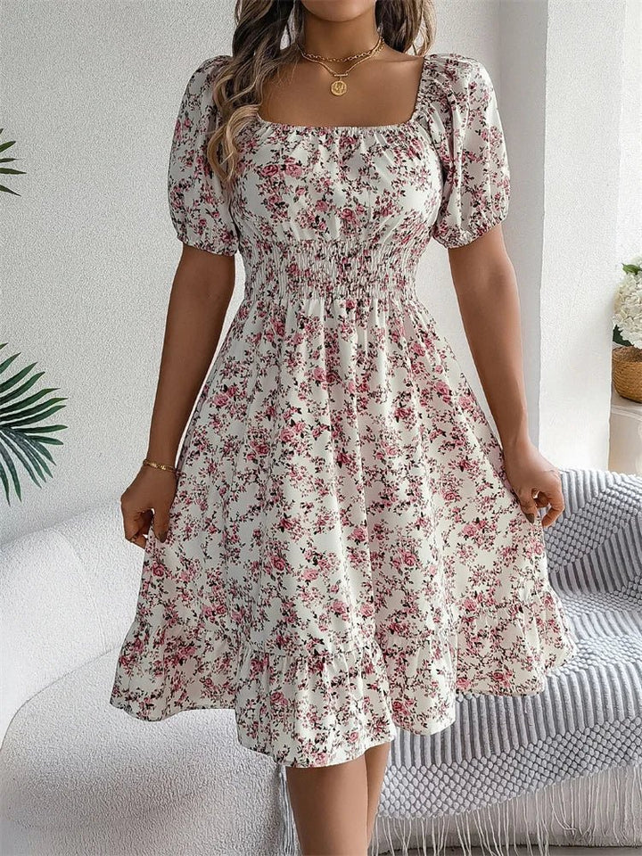 Chic women's floral smocked midi dress, elegant puff sleeves, perfect for day or evening wear.