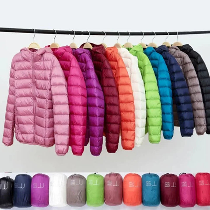 Packable & insulated women's jacket with hood. Lightweight winterwear, weather-resistant for travel.