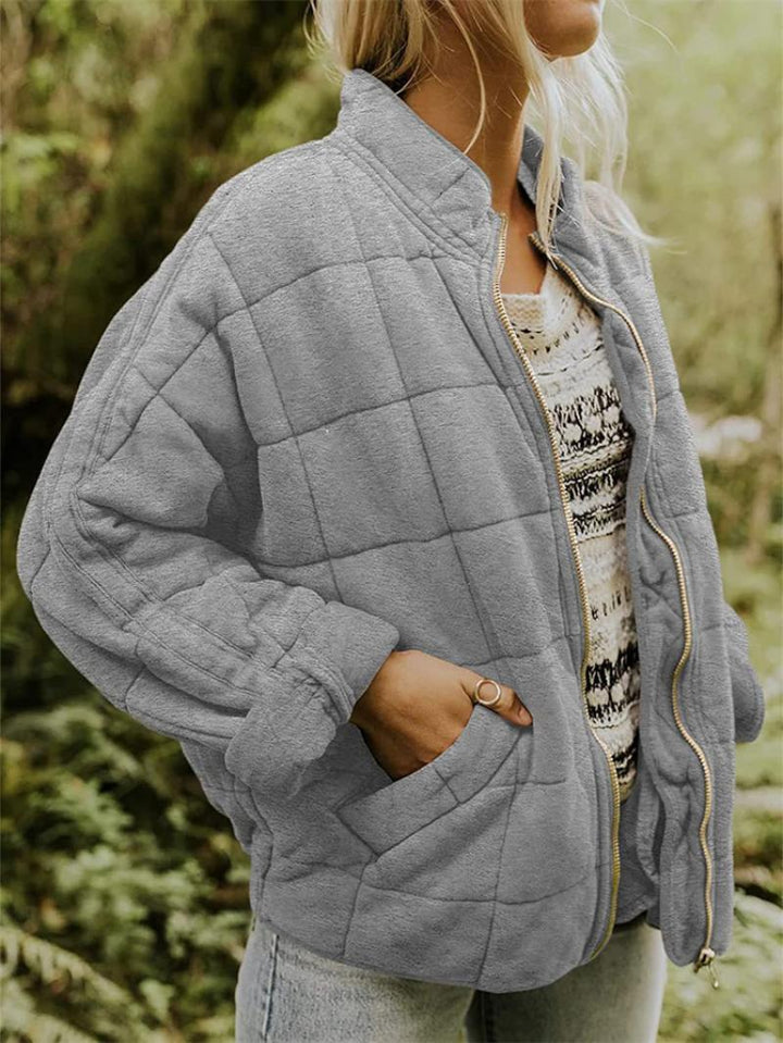 Lightweight quilted women's jacket with a sleek zipper closure, ideal for spring and casual elegant outfits.