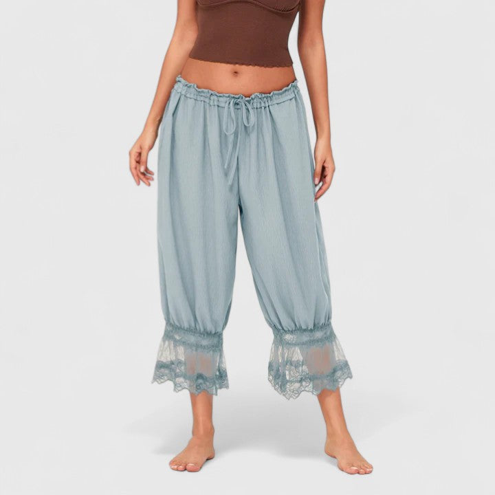 Back view of comfortable women's loose fit trousers with stylish patchwork and mid-rise.