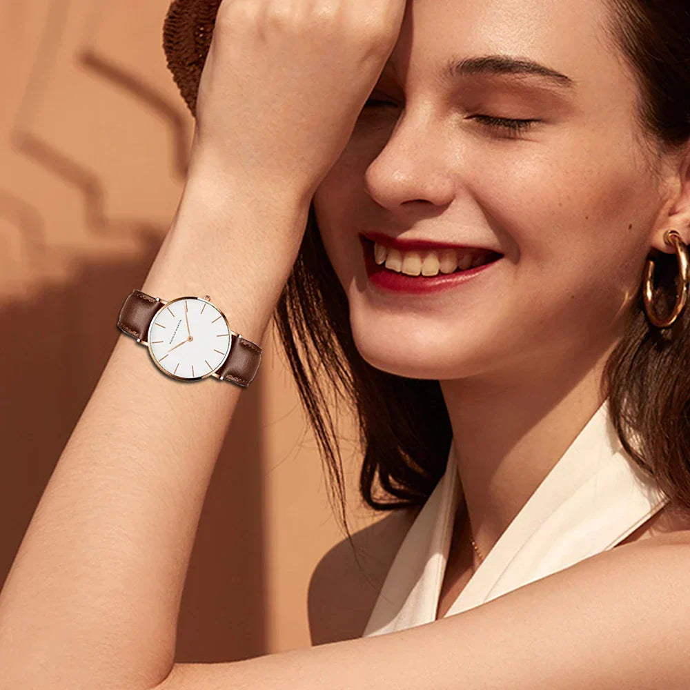 Elegant women's leather watch with a round minimalist dial, a timeless fashion accessory.