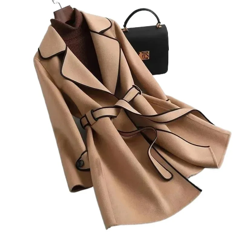 Woman modeling a stylish tailored longline trench coat, elegant fall fashion, outerwear for women.