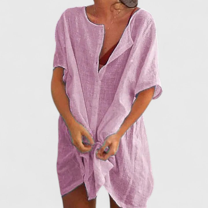 Close-up of the elegant women's tunic dress fabric, showing its quality and summer-ready texture. Chic detail.