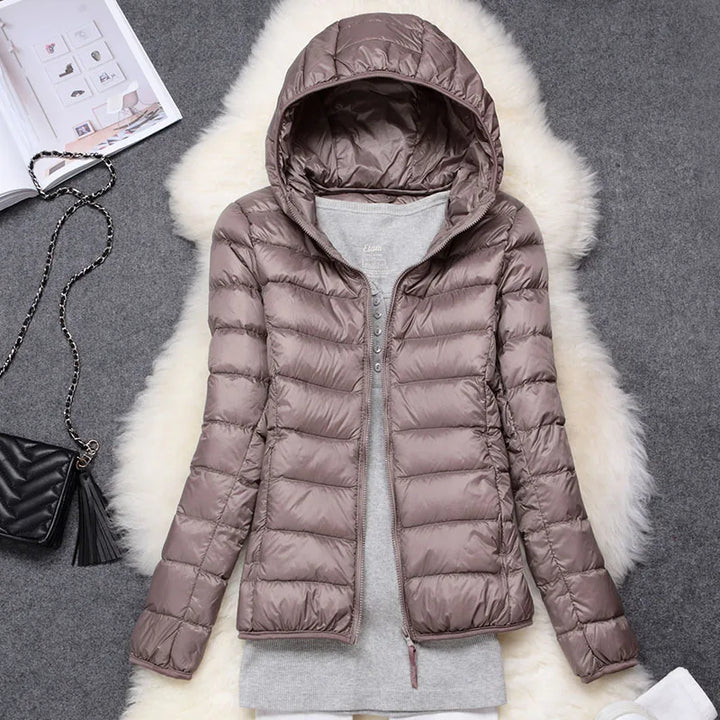 Warm & packable women's hooded insulated jacket. Ultra-light design for winter outdoor activities.