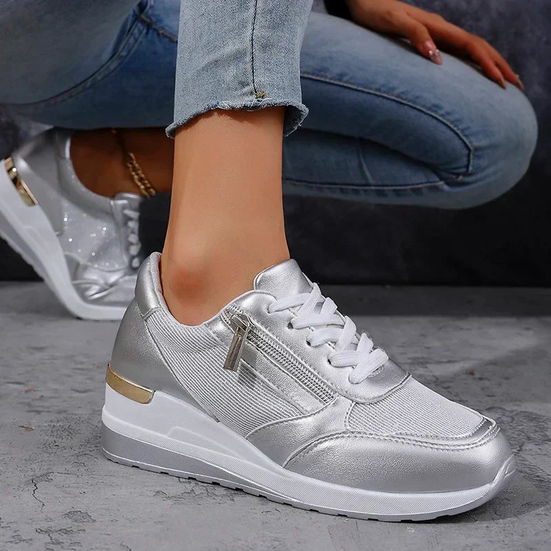 Silver metallic orthopaedic platform trainers for women, offering superior comfort and a trendy side zip.