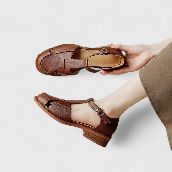 Women's comfortable closed-toe T-strap sandals in brown, featuring an elegant block heel.