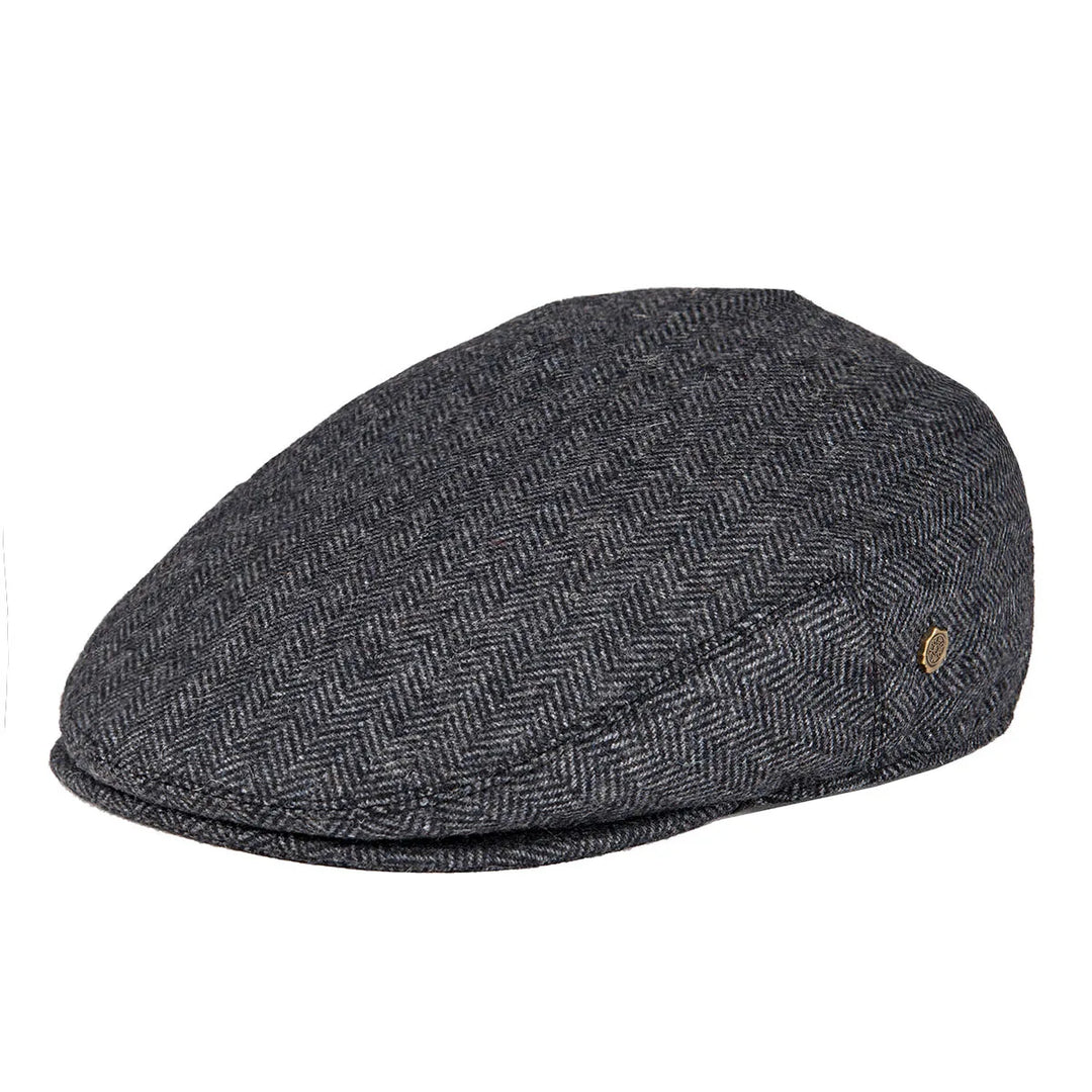 Close-up of the herringbone fabric on a men's flat cap, showcasing texture.