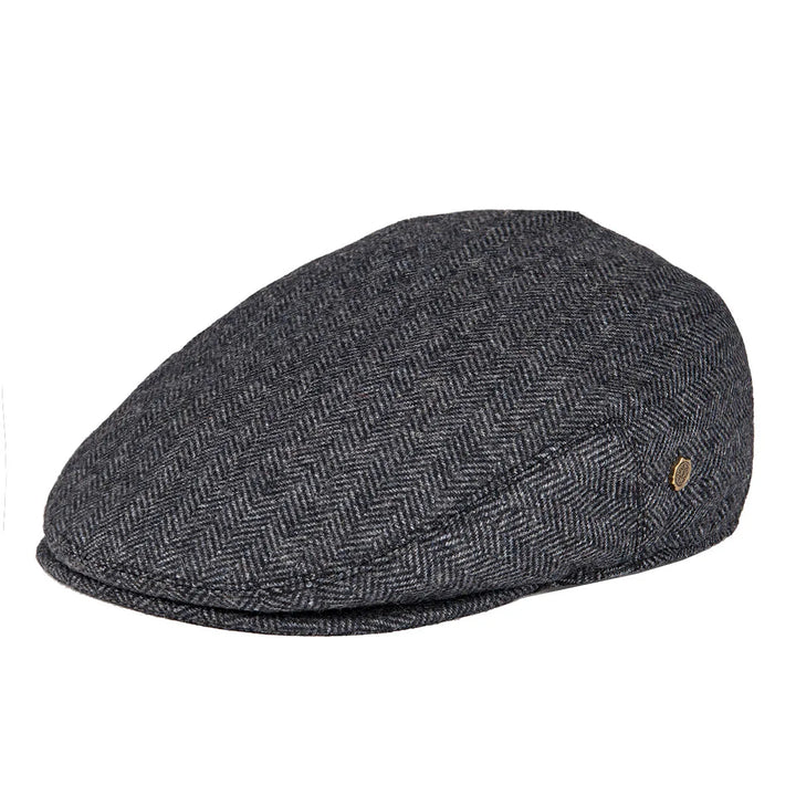Close-up of the herringbone fabric on a men's flat cap, showcasing texture.