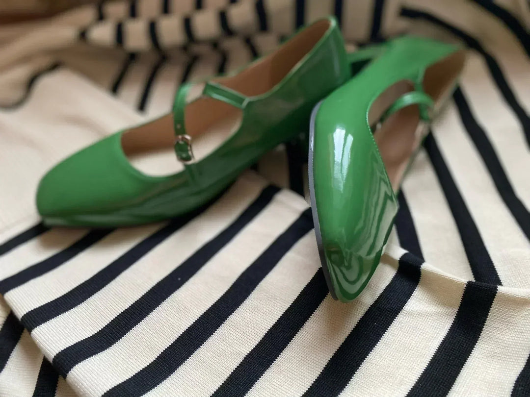 Close-up of shiny black women's orthopedic block heels, offering comfort & foot pain relief.