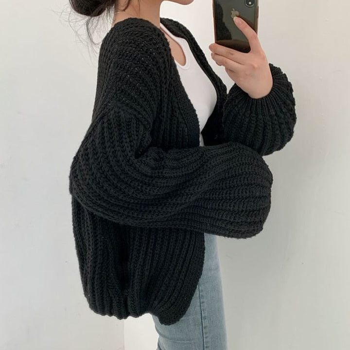 Stylish women's chunky knit cardigan featuring balloon sleeves & a relaxed, open-front design. Cozy fall wear.