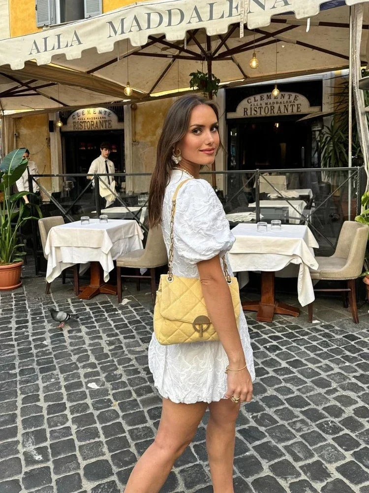 White floral mini dress for women, featuring a romantic print, puff sleeves, and a comfortable, elegant fit.
