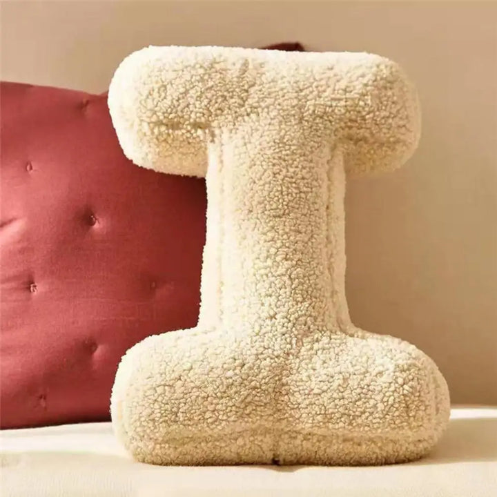 Chic velvet 'E' alphabet pillow, a soft furnishing for modern home interiors & initial accents.
