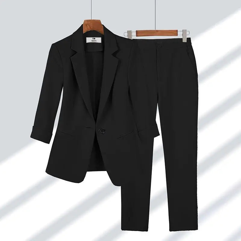 Sophisticated women's business suit. Full view of elegant blazer jacket & tailored trousers set.
