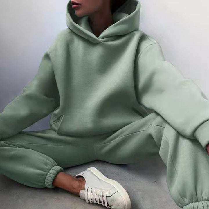 Close-up of women's jogging set hoodie, highlighting soft polyester blend fabric, drawstring, and relaxed fit.