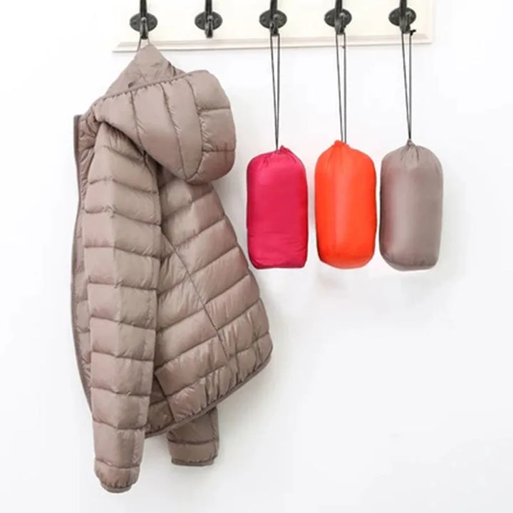 Women's ultra-light hooded insulated winter jacket. Packable outerwear for travel & everyday comfort.