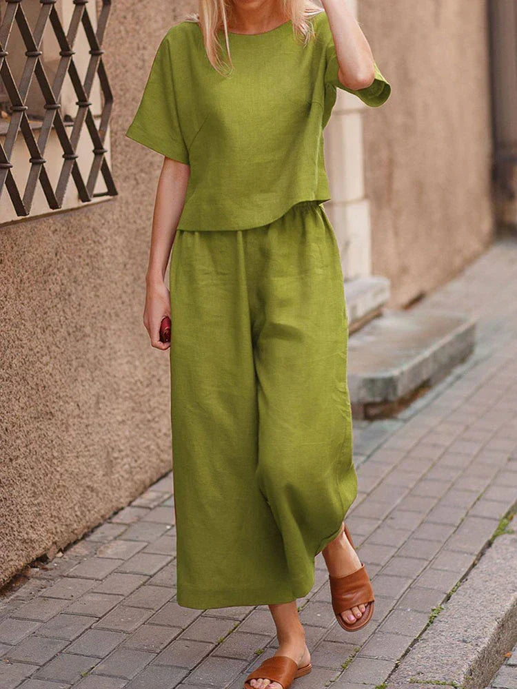 Stylish women's linen two-piece outfit set featuring a relaxed fit top and wide-leg trousers for summer.