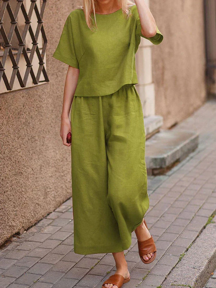 Stylish women's linen two-piece outfit set featuring a relaxed fit top and wide-leg trousers for summer.