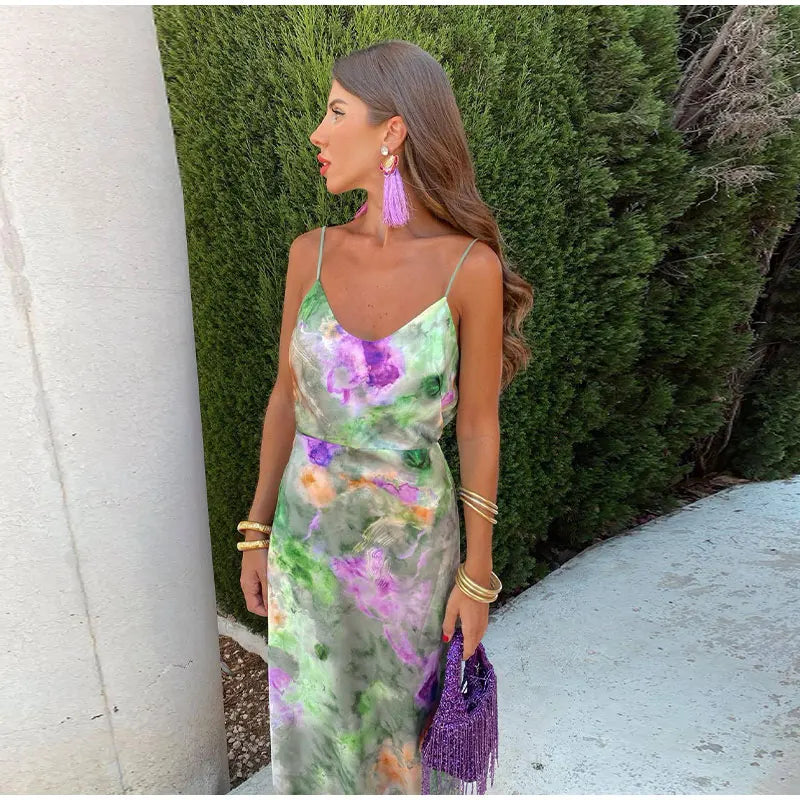 Flowing women's tie-dye halter maxi dress with a flattering silhouette & a cute removable bow, great for beach or resort.