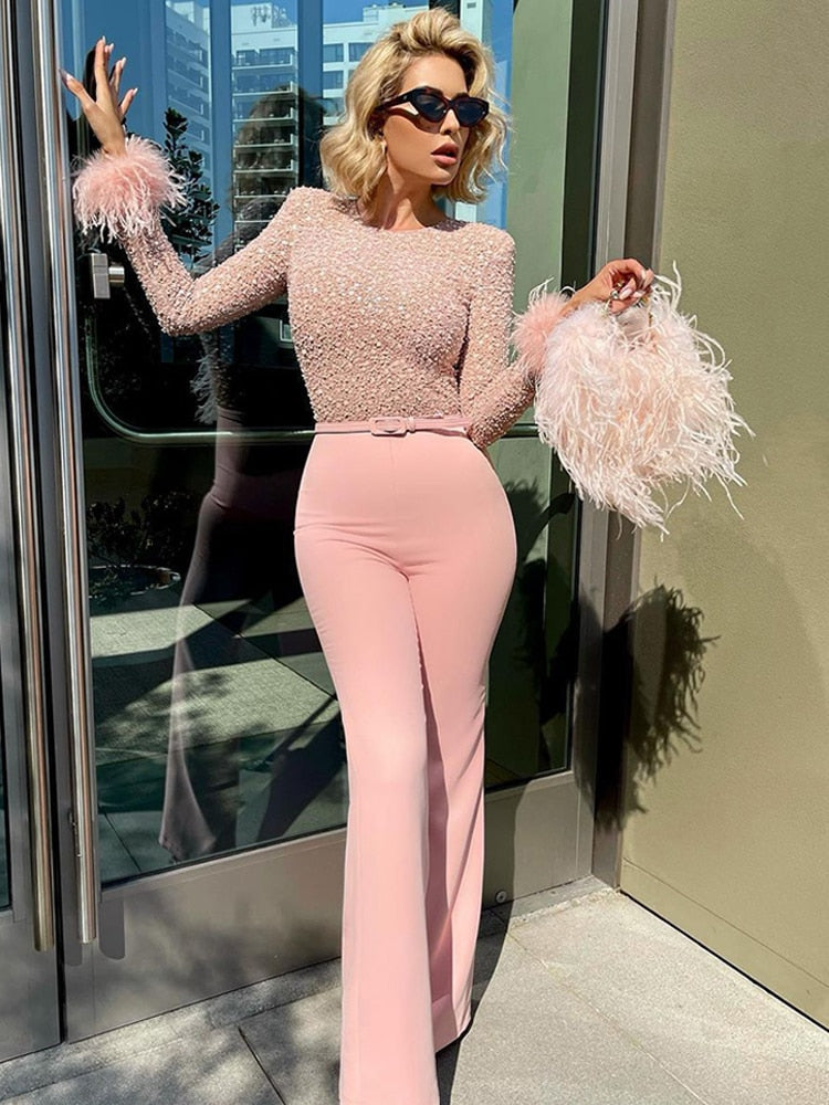 Elegant sequin feather jumpsuit for women, a sparkling party outfit with long sleeves & flattering flared leg.