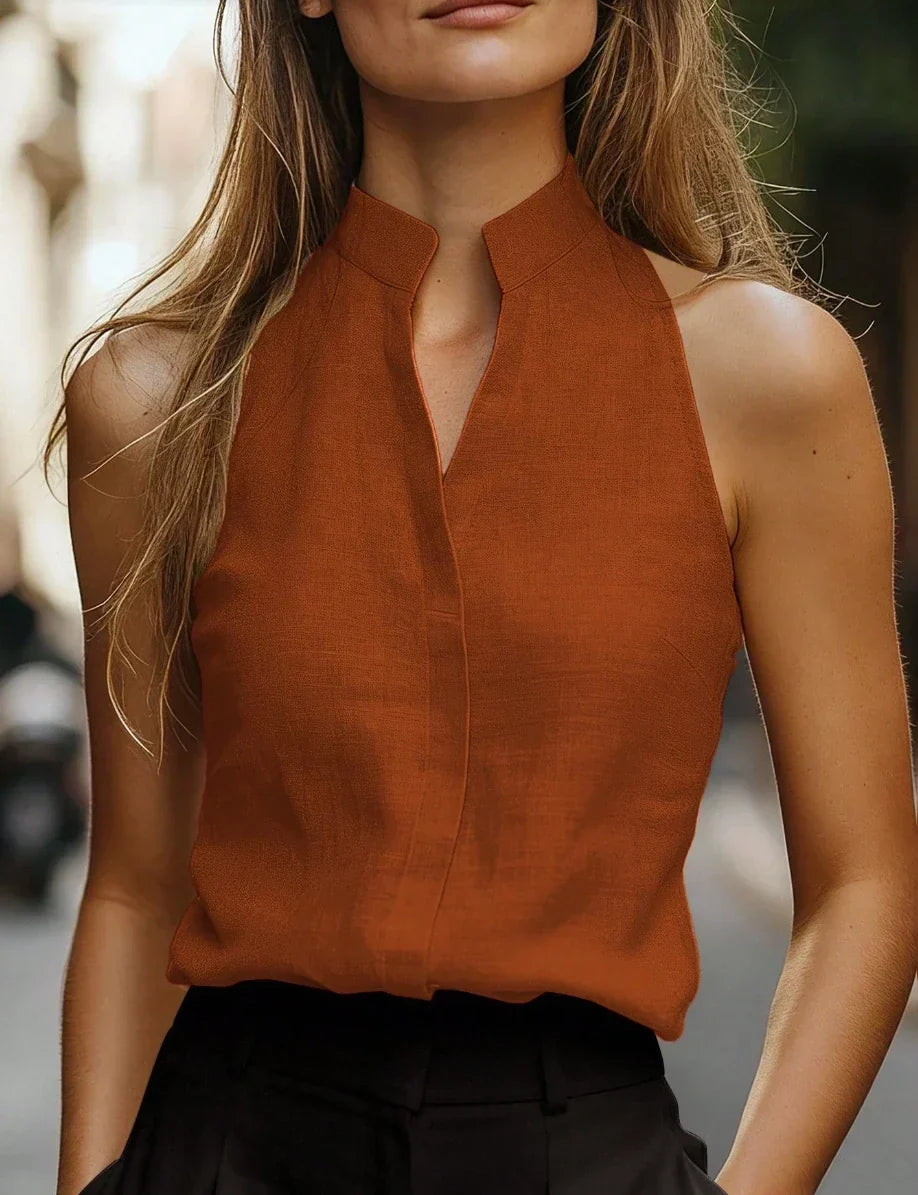 Chic women's sleeveless blouse showcasing a unique V-notch collar, a modern fashion top for any smart occasion.