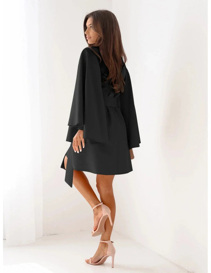 Chic women's solid long-sleeve mini dress, ideal for elegant evening wear or sophisticated casual occasions.