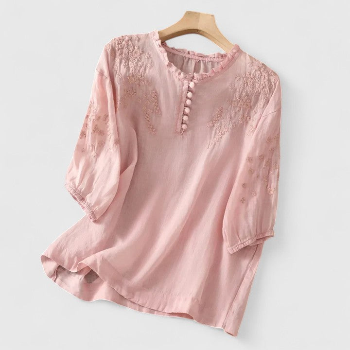 Elegant women's embroidered button-front blouse. Perfect for casual chic or versatile spring/summer fashion.