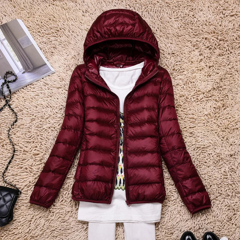 Women's ultra-light insulated jacket, hooded. Perfect for cold winter travel & outdoor comfort.