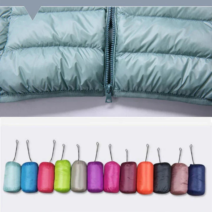 Lightweight women's winter jacket, hooded & insulated. Travel-ready, weather-resistant outerwear.
