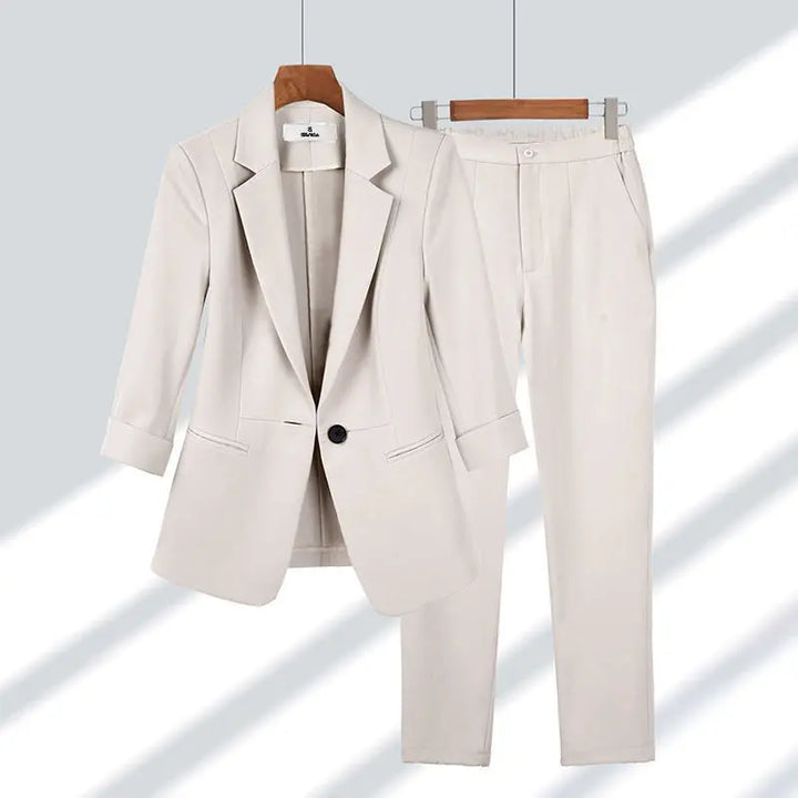 Chic women's power suit set, featuring a stylish blazer jacket & matching trousers for office fashion.