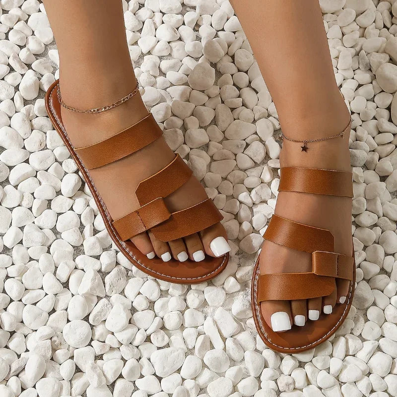 Women's multi-strap flat slide sandals in a minimalist design, perfect for summer casual wear & everyday comfort.