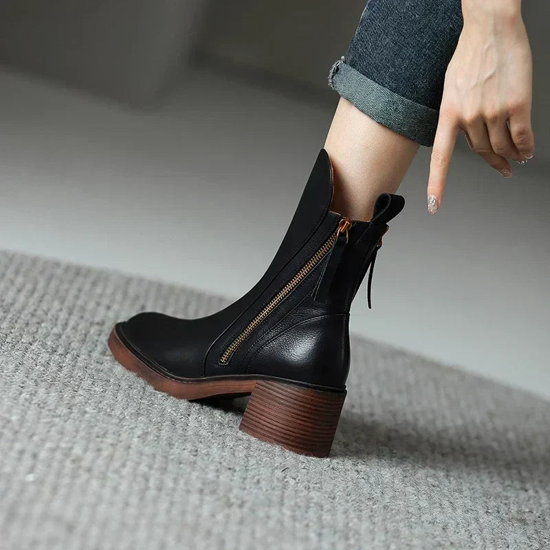 Comfortable women's black ankle boots with elegant design, ideal for walking & versatile everyday style. Slip-on.