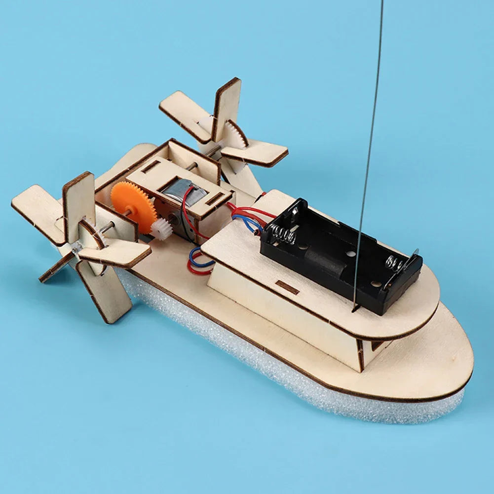 Kids' science project: understanding electricity & mechanics with a wooden toy boat kit.