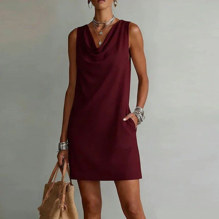 Womens casual cowl neck mini dress, sleeveless A-line style with practical pockets. Great for summer fashion.