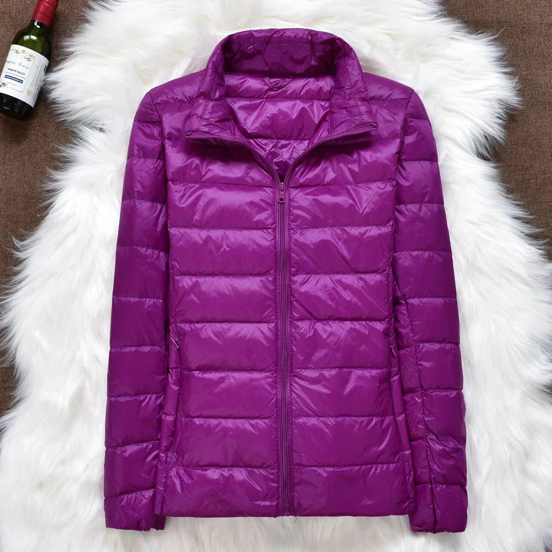 Travel-friendly women's hooded insulated jacket. Ultra-light, packable for winter adventures.