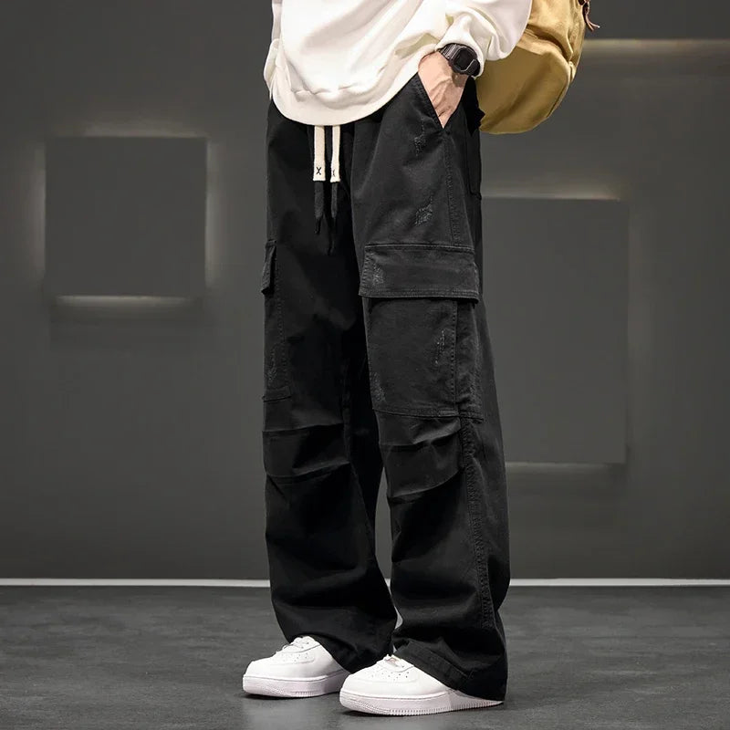 Men's wide leg cargo trousers with drawstring waist & flap pockets for a relaxed, casual fit.