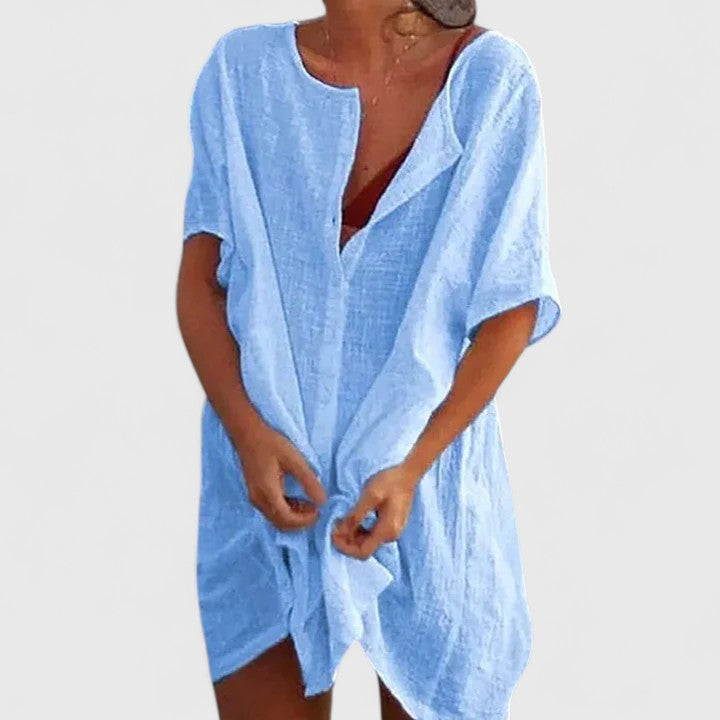 Model wearing a flowing women's elegant tunic dress, showcasing its flattering fit and summer style. Casual chic.
