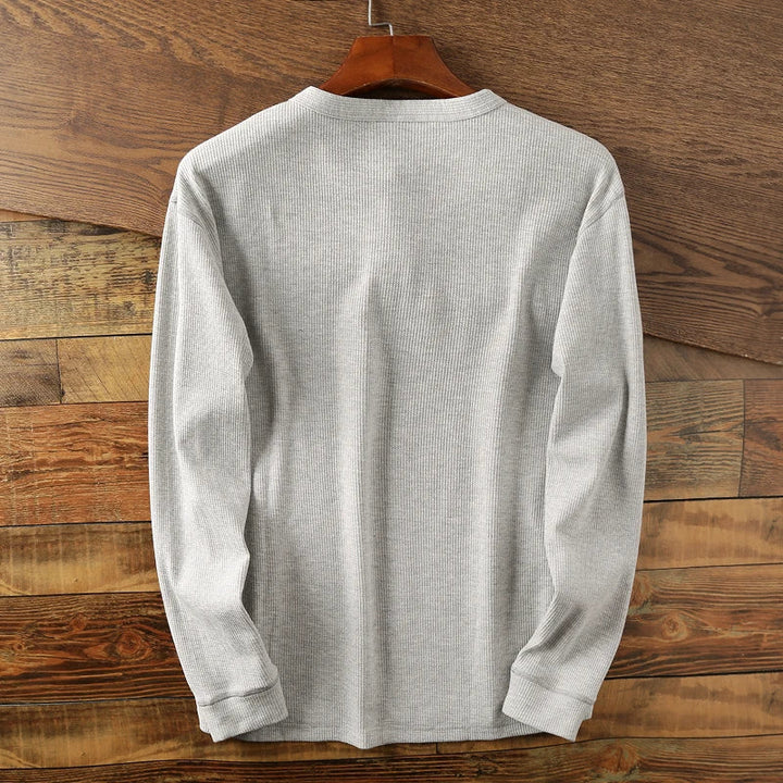 Comfortable men's waffle shirt, a breathable long sleeve henley for versatile daily style.