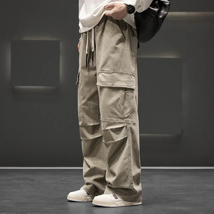Men's wide leg cargo trousers with drawstring & flap pockets; ideal for a relaxed, everyday look.