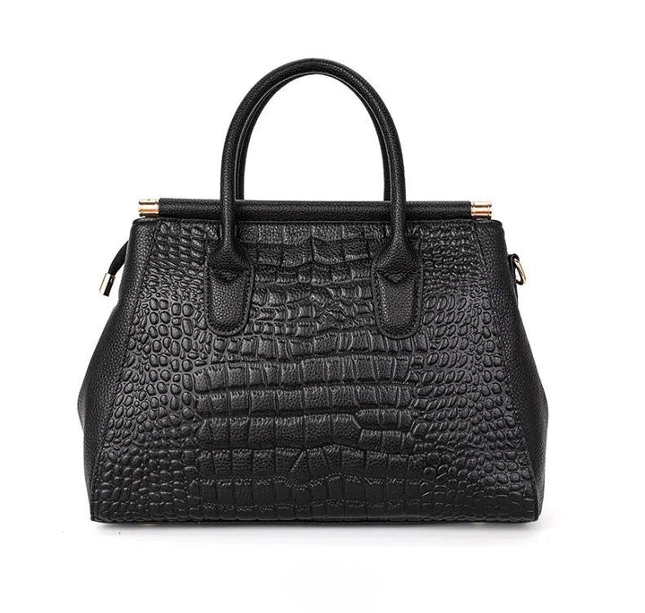 Chic women's fashion accessory: embossed leather handbag with organized compartments & sturdy top handle.