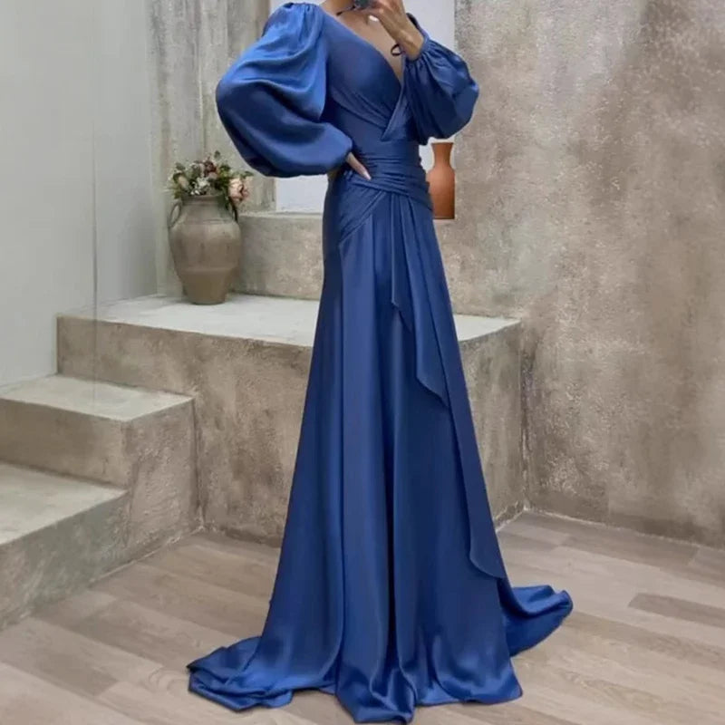 Women's elegant blue flowing maxi dress for special occasions. Ideal formal evening gown or event wear for weddings.