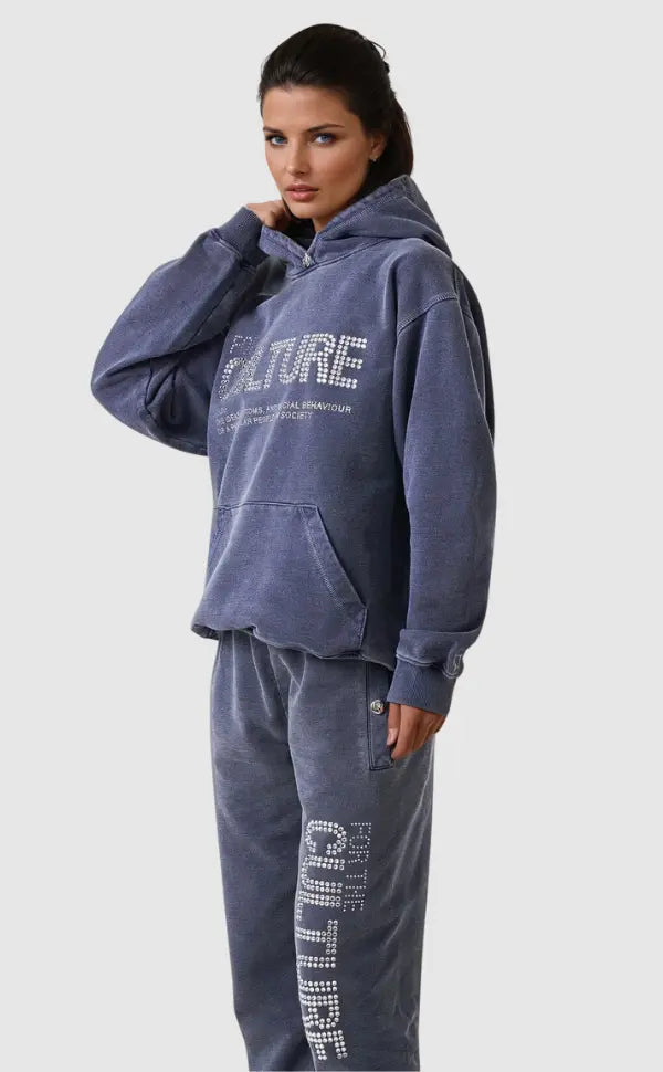 Women's oversized vintage wash graphic hoodie with a bold streetwear print, perfect for casual fall fashion.
