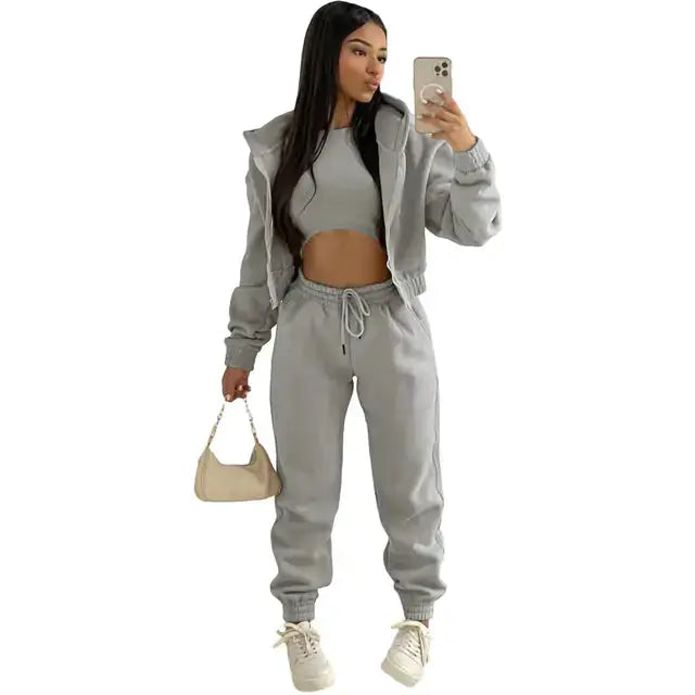Effortless women's 3-piece casual set: cropped hoodie, relaxed fit joggers, & bralette.