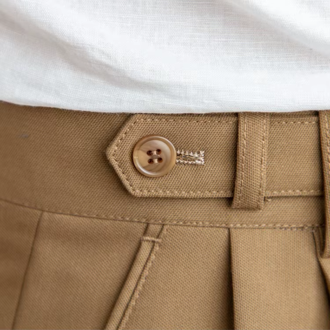 Smart men's pleated chino trousers, available in black, beige, and camel.