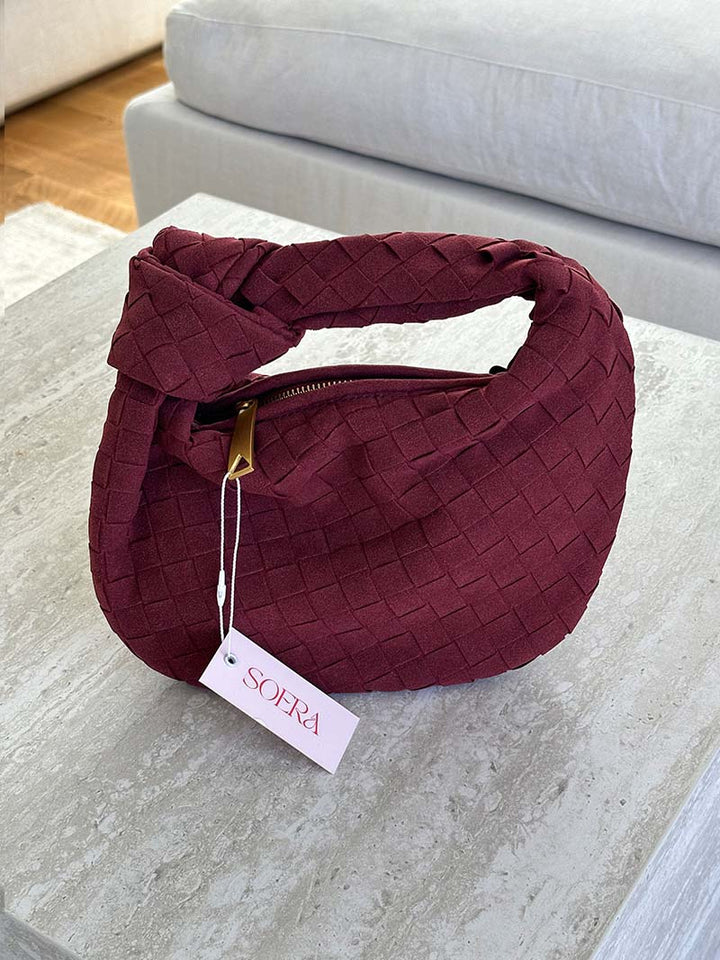 Versatile women's compact suede handbag with attractive braided detail.