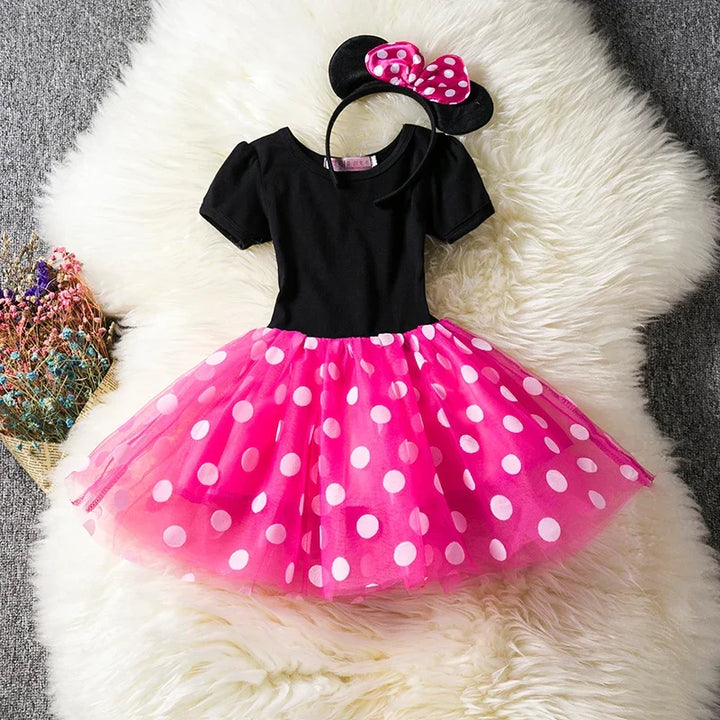 Cute girls' Minnie Mouse costume featuring a red polkadot dress & iconic ear headband.