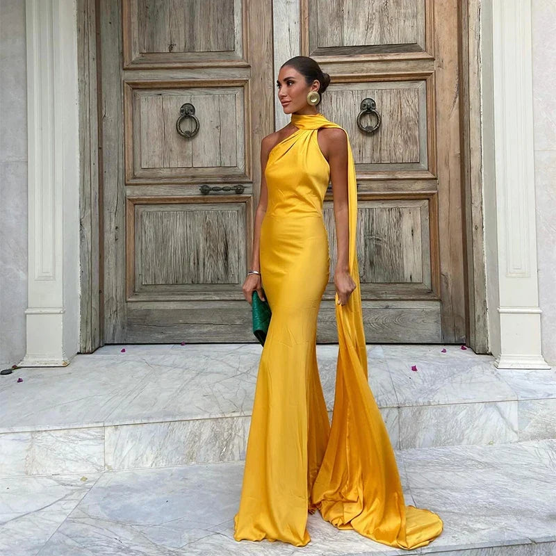 Elegant women's one-shoulder cape maxi dress for formal events. Sophisticated evening gown, perfect for a gala.