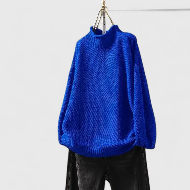 Close-up of soft textured knit fabric on a women's mock neck jumper, ideal for cozy fall fashion.
