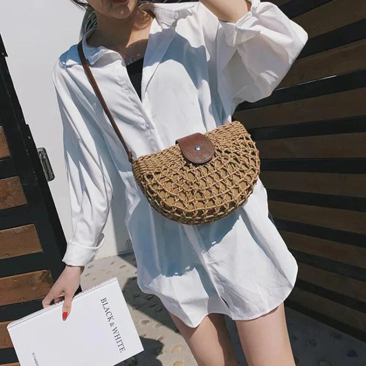 Braided straw shoulder bag for women, featuring a distinctive web design, in a natural beige tone.