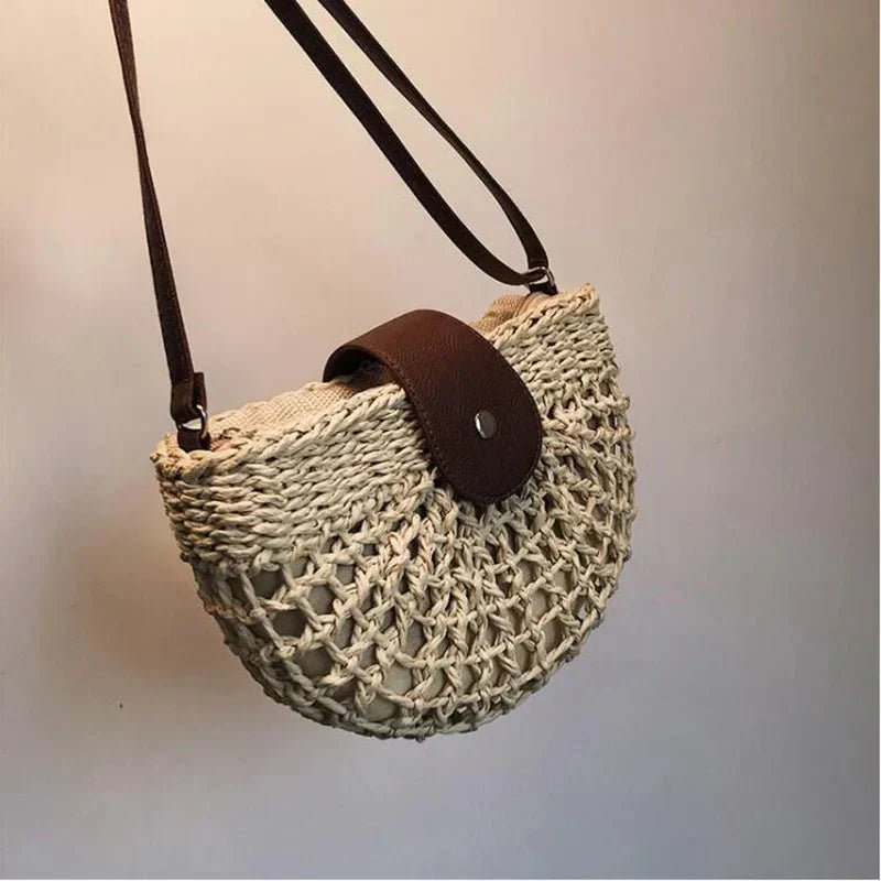 Summer-ready natural straw bag for women, featuring a unique web weave and comfortable shoulder strap.