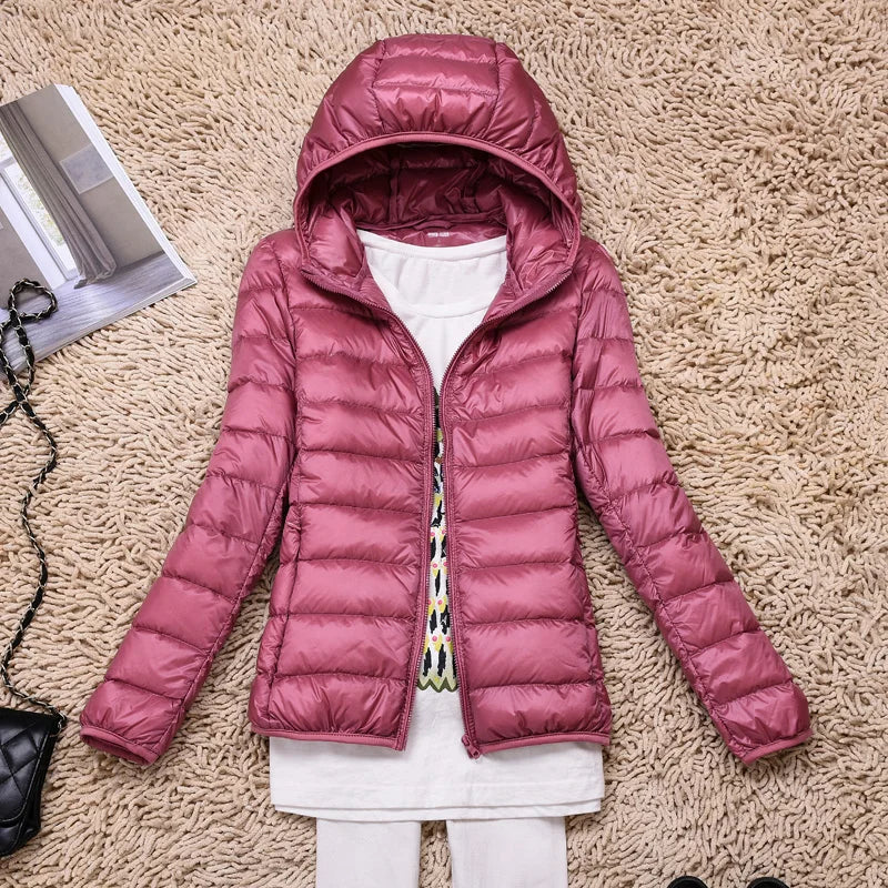 Packable women's hooded jacket, ultra-light. Insulated outerwear for travel and cold weather.
